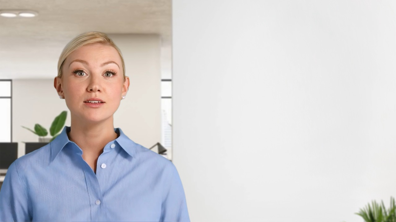 A presenter speaking to camera in an open-plan office